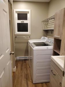 a small kitchen with a dishwasher and a window at Saratoga beach cottage, private non-resort, easy beach access, 35mins Mt Washington in Oyster Bay