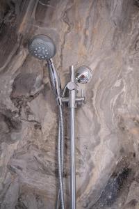 a shower head sitting on top of a rock at Mount Rumney Escapes Seaview House 2 - Eagle House in Mount Rumney