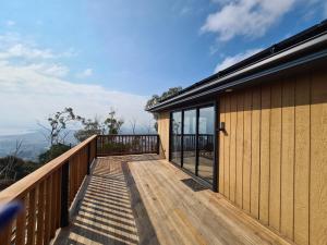 a wooden deck with glass doors on a house at Mount Rumney Escapes Seaview House 2 - Eagle House in Mount Rumney