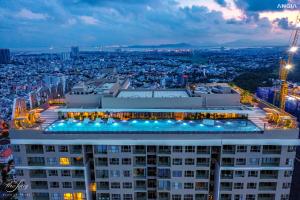 a building with a pool on top of it at night at The Sóng Condotel in Vung Tau City - The Sóng Real Company in Vung Tau