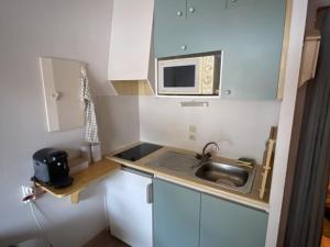 a small kitchen with a sink and a microwave at Studio Le Biot, 1 pièce, 5 personnes - FR-1-573-55 in Le Biot