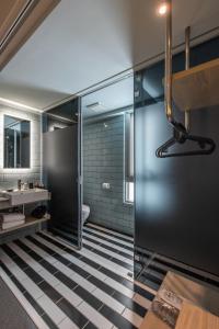 a bathroom with a black and white checkered floor at Ramble Hotel in Taichung