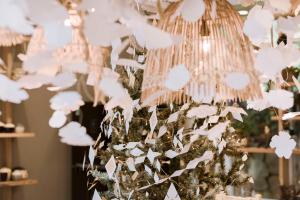 a chandelier with white paper flowers hanging from it at Dahlia Dalat in Xuan An