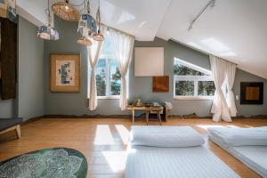 a living room with two beds and a table at Dahlia Dalat in Xuan An