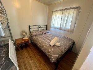 a bedroom with a bed with a pillow on it at Family Getaway Cabin 50 in Broadwater