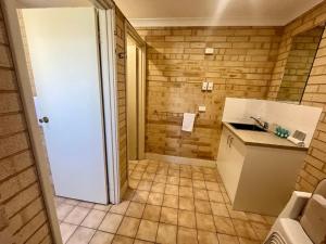 a small bathroom with a sink and a counter at Family Getaway Cabin 50 in Broadwater +21 photos