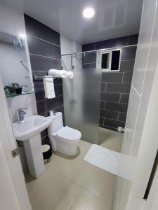 a bathroom with a toilet and a sink at Hotel el barco in Azua de Compostela