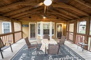 a porch with a table and chairs and a ceiling fan at Mountain View GetAway in Stone Mountain