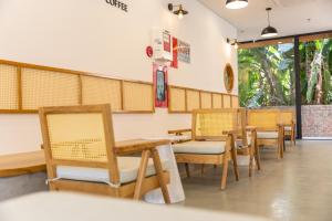 a row of tables and chairs in a restaurant at LAGOM APARTMENT AND HOTEL in Da Nang