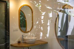 a bathroom with a sink and a mirror at LAGOM APARTMENT AND HOTEL in Da Nang