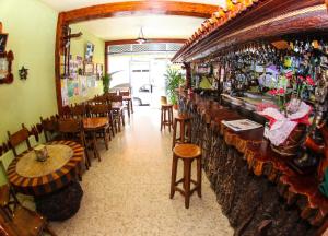 a restaurant with a bar with tables and chairs at El Molino in Melide