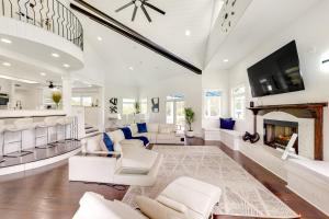 a living room with white furniture and a fireplace at Tybee White Mansion in Tybee Island