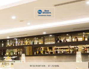 a bar with a lot of bottles of alcohol at Best Western Chinatown Hotel in Yangon
