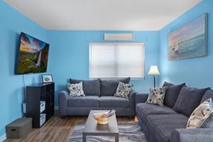 a blue living room with a couch and a table at Beautiful Blue Ocean Condo in Myrtle Beach