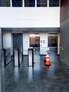 an empty room with a caution cone in a building at Cómodo Departamento (Estación Central) in Santiago