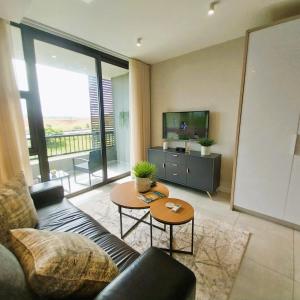 a living room with a couch and a table at Zimbali Lakes Boulevard Suites, Unit148 in Ballito