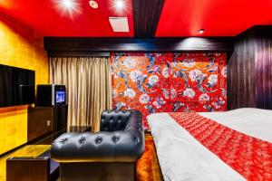 a hotel room with a bed and a television at Hotel Lotus Umeda -Adult Only in Osaka