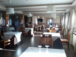 a dining room with tables and chairs and tablesearcher at Hotel Buenos Aires in Villafr&iacute;a de Burgos