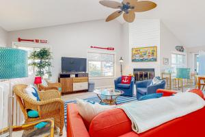 a living room with a red couch and chairs at Town of South Bethany --- 125 Elizabeth Way in Bethany Beach