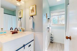a white bathroom with a sink and a window at Town of South Bethany --- 125 Elizabeth Way in Bethany Beach +16 photos