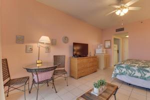 a bedroom with a bed and a table and chairs at Pirates Bay A415 in Fort Walton Beach