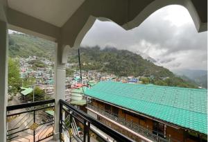 a balcony with a view of a mountain at Mount Khang Hotel in Lachen