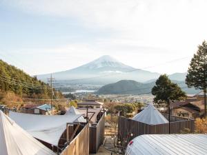 a view of a snow covered mountain with tents at Dot Glamping 富士山 in Fujikawaguchiko