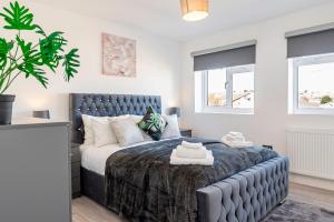 a bedroom with a bed and a potted plant at Luxury Holiday Home Free Parking By the Beach in Warden