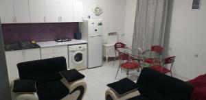 a kitchen with a table and chairs and a refrigerator at AKCURATE Home 105/1 in Yerevan