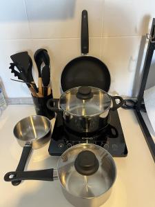 einen Herd mit zwei Töpfen und Pfannen drauf in der Unterkunft SG Resort Residence - Beach & Waterpark in Kuantan