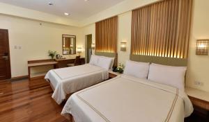 two beds in a hotel room at Kabayan Hotel Pasay in Manila +26 photos