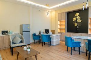 a living room with blue chairs and a table at 85 SOHO Hotel & Apartment in Phnom Penh