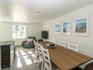 a living room with a wooden table and chairs at 1 Kents Mews in Torquay