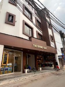 una tienda frente a un edificio con el comedor cafetería en The Divine Oak en Katra