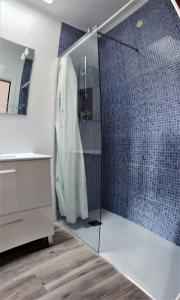 a bathroom with a shower with a glass door at Apartamento Playa de Ris in Noja