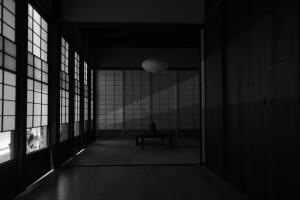 an empty room with a table and windows at 屋子 Wuz Marutamachi in Kyoto