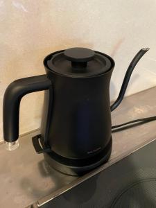 a black tea kettle sitting on top of a stove at 919KOBE ARIMA in Kobe