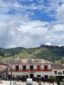 a town with a hill in the background with a building at Hotel Colonial Abejorral in Abejorral