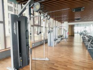 a gym with a large room with cardio equipment at Melaka Town Homestay Bali Residences Apartment in Melaka