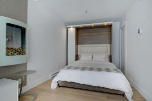 En eller flere senge i et værelse på Les Immeubles Charlevoix - Le 760306