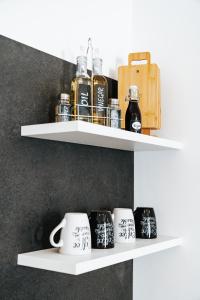 a shelf with coffee mugs on it at Gemütliche Wohnung im Zentrum in Zeltweg