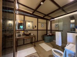 a large bathroom with a sink and a toilet at The Machan in Lonavala