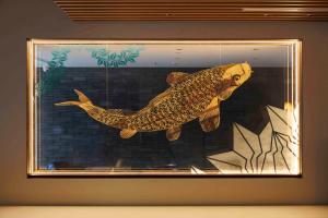 a stuffed fish in a picture in a frame at Gion Elite Terrace in Kyoto