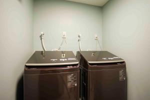 two washing machines in a corner of a room at Gion Elite Terrace in Kyoto