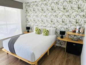 a bedroom with a bed with a floral wallpaper at Tessa's on the Beach in Gold Coast