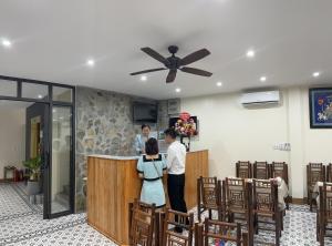 a group of people standing at a bar in a room at Tam Coc Paradise Homestay in Ninh Binh +37 photos