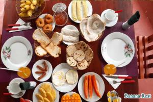 a table topped with plates of bread and vegetables at Banana Rest Sigiriya in Sigiriya