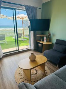 a living room with a couch and a table at Tessa's on the Beach in Gold Coast