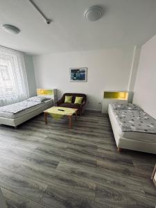 a room with two beds and a couch at FeWo`s Katharina in Bremerhaven