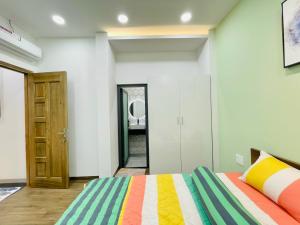 a bedroom with a bed with a colorful blanket at Thái Vân Home in Ho Chi Minh City